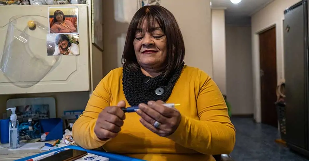 Woman with diabetes sat at home